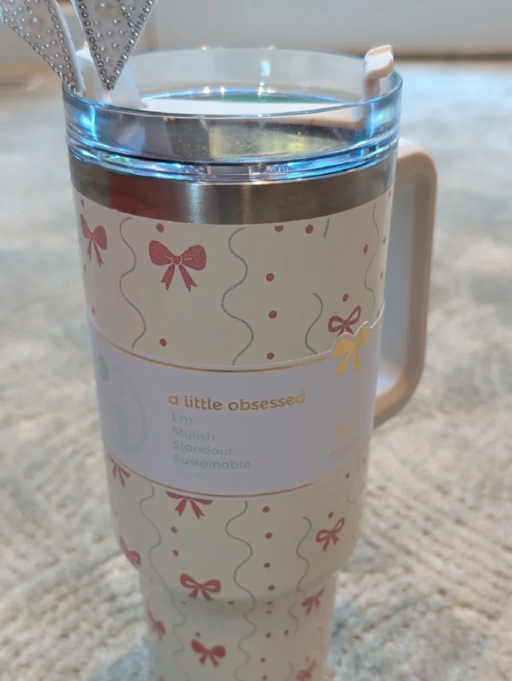 White Patterned Travel Mug with Handle and Decorative Bow